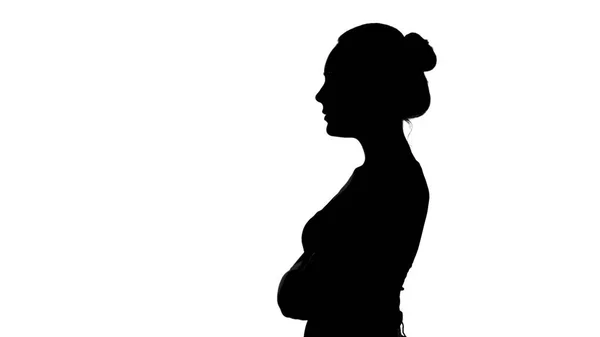 Frauensilhouette im Profil mit verschränkten Armen auf weißem Hintergrund — Stockfoto