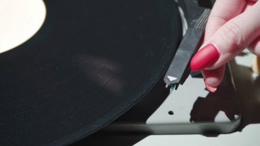 Kırmızı tırnaklı ve retro gramofonlu bir kadın.