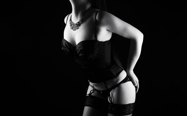 Black and white image of the young woman in silk lingerie with arms on hips — Stock Photo, Image