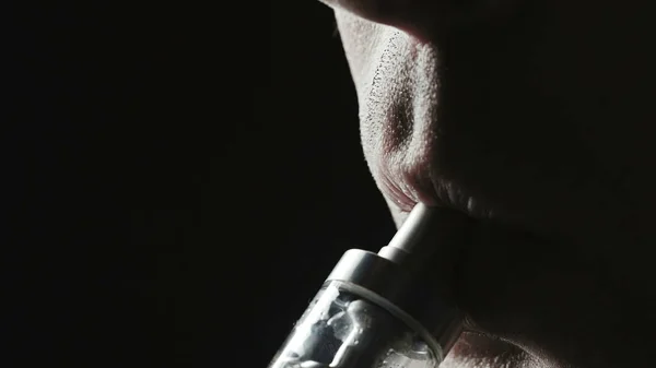 Closeup photo of smoker man on black