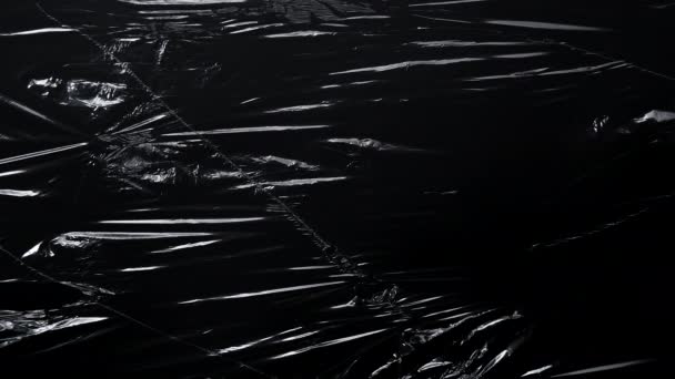Video van plastic wikkel met krassen op zwart — Stockvideo