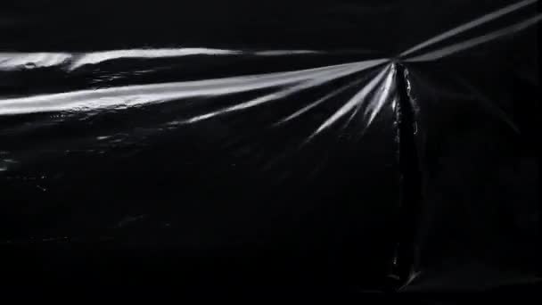 Patroon van cellofaan plastic wrap met vodden gat — Stockvideo