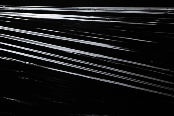 Texture of the plastic wrap on black background