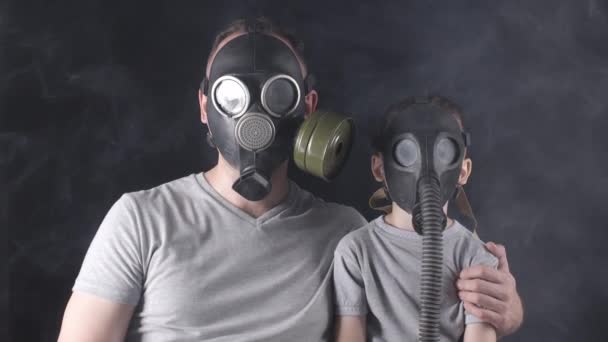 Shooting of man and five-year-old boy in gas masks — Stock Video