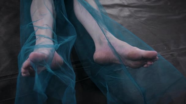 Shooting of lying female bare foot in blue fabric — Stock videók