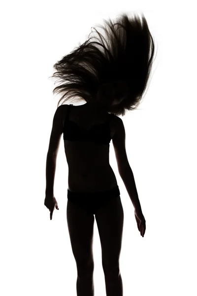 Silhouette of dancing girl with waving hair — Stock Photo, Image