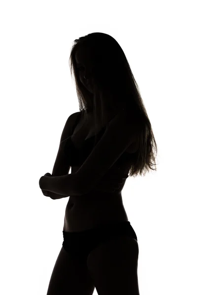 Silhouette of teenage girl with arms crossed — Stock Photo, Image