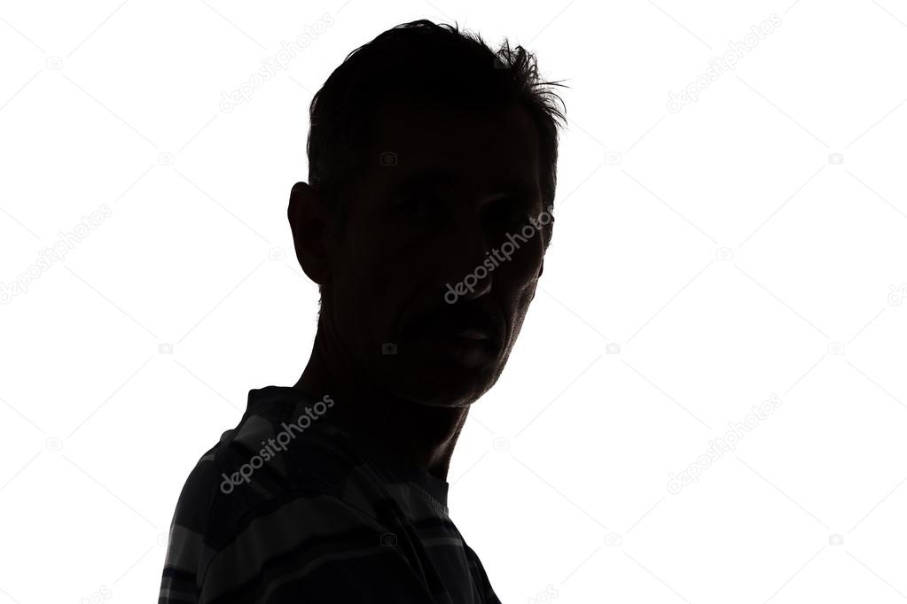 Silhouette of a man looking at camera