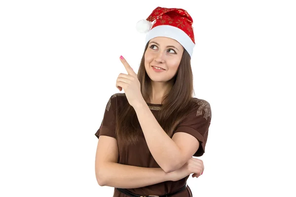 Foto de una mujer joven mostrando algo en el sombrero de Navidad — Foto de Stock