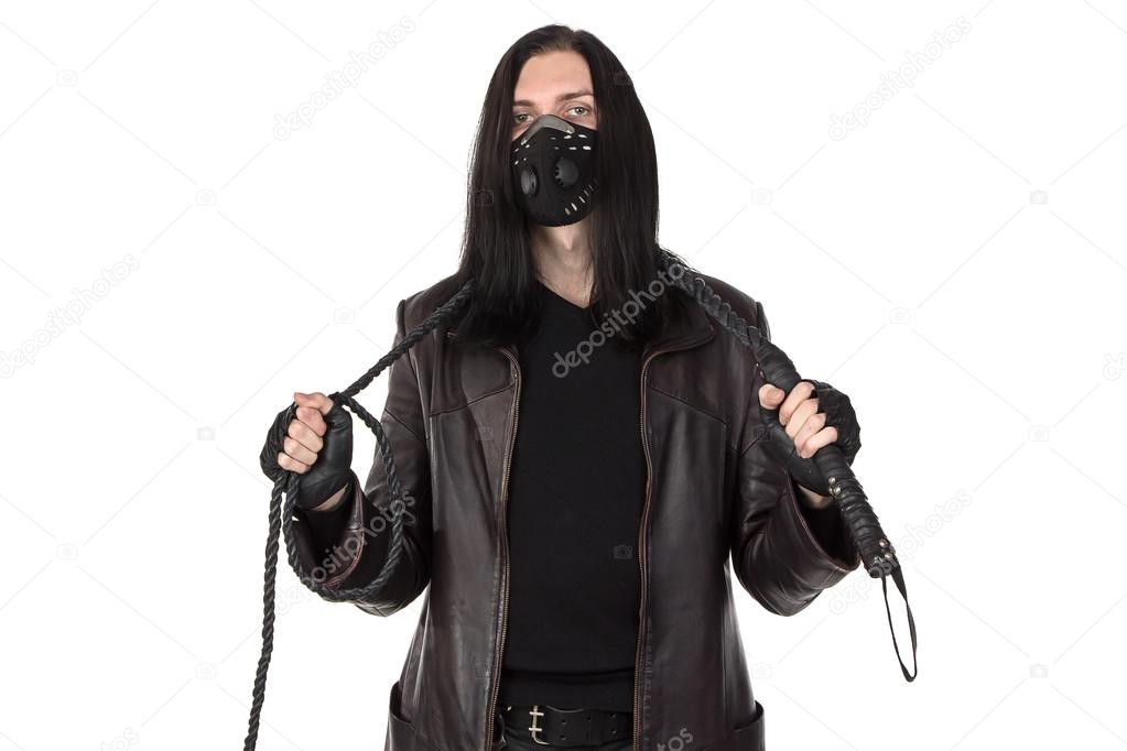 Photo of the young man with whip in black mask