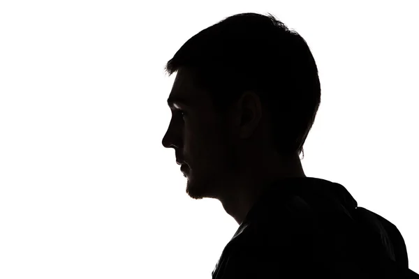 Portret van jonge mans silhouet in bonte mantel — Stockfoto