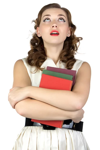 Pinup young woman with books looking up — Stock Photo, Image