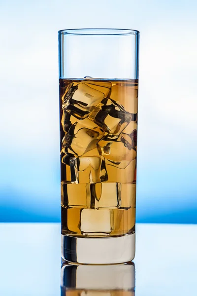 Glass of tea on blue background — Stock Photo, Image