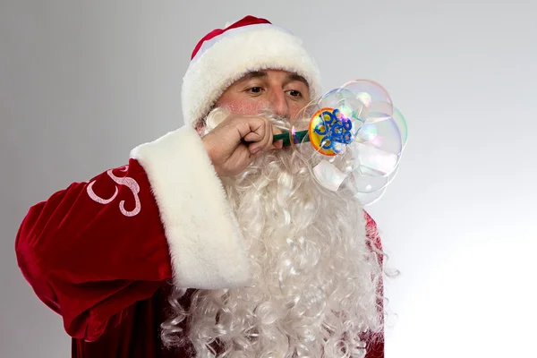 Photo of Santa blowing soap bubble — Stock Photo, Image