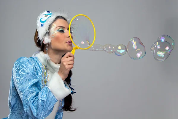 Portrait of beauty snow maiden blowing bubble — Stock Photo, Image
