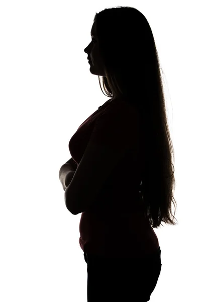 Silhouette of teenage girl standing in profile — Stock Photo, Image