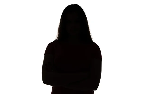 Silhouette of teenage girl with arms crossed — Stock Photo, Image