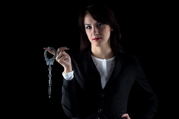 Image serious woman with pair of handcuffs — Stock Photo, Image