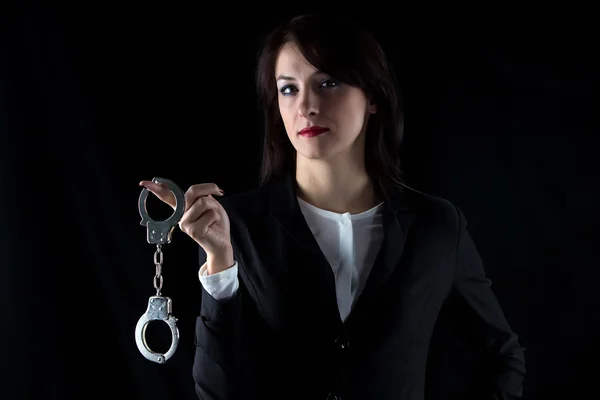 Photo serious woman with pair of handcuffs — Stock Photo, Image