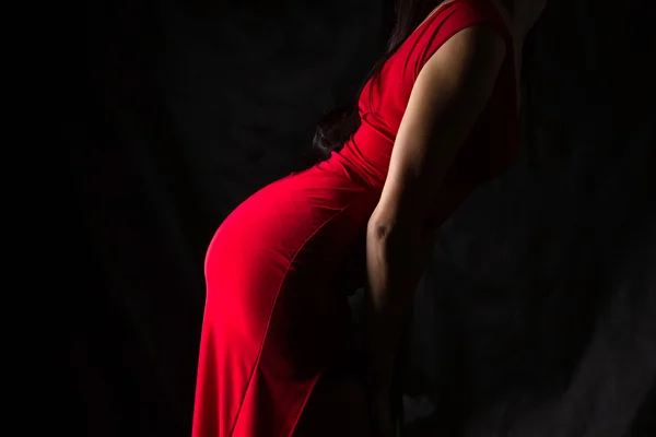 Photo of learned forward woman in red dress — Stock Photo, Image