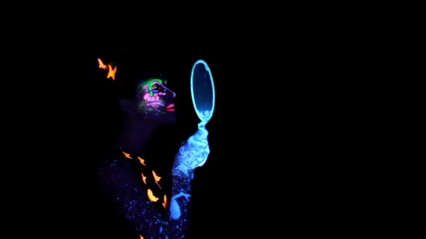 Woman with luminous make up blowing bubbles — Stock Video