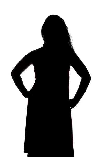 Silhouette of curvy woman with hands on hips — Stock Photo, Image