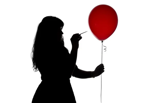 Mujer de imagen perforada con un globo de aguja — Foto de Stock