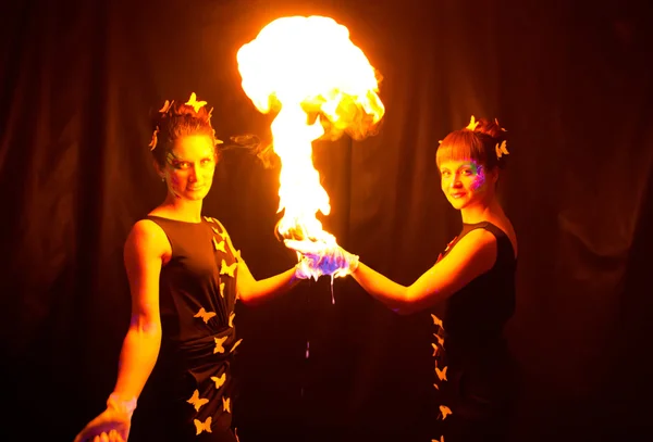Photo of two women holding fire — Stock Photo, Image