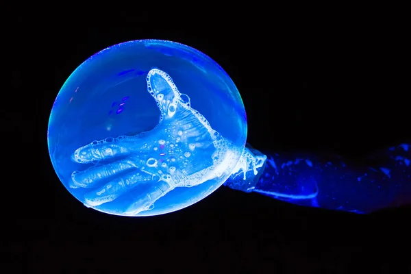 Photo of blue luminous glove and bubble — Stock Photo, Image