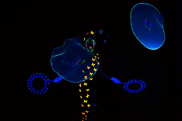 Image of woman with blue luminous bubbles