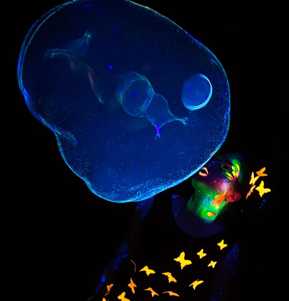 Image of woman blowing up luminous bubbles — Stock Photo, Image