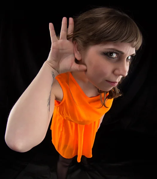 Image of listening woman in orange dress — Stock Photo, Image