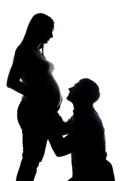 Silhouette of happy husband looking at pregnant wife — Stock Photo, Image