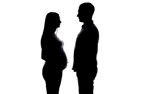 Silhouette of pregnant wife and husband — Stock Photo, Image