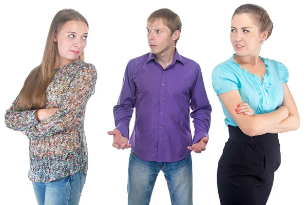 Puzzled blond man and two young women — Stock Photo, Image