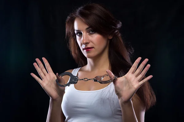 Woman in white t-shirt with handcuffs — Stock Photo, Image