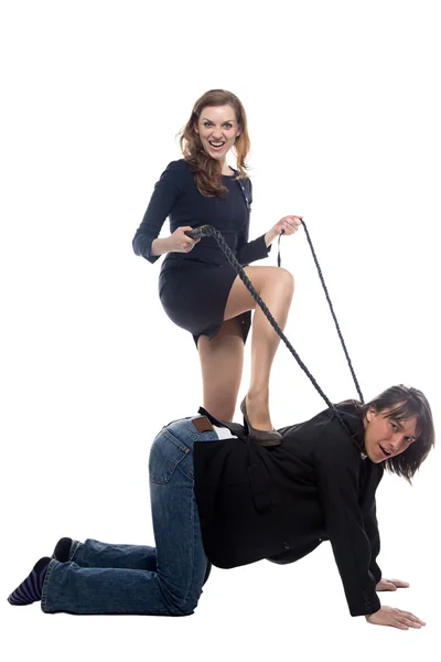 Angry woman putting leg on man in black jacket — Stock Photo, Image