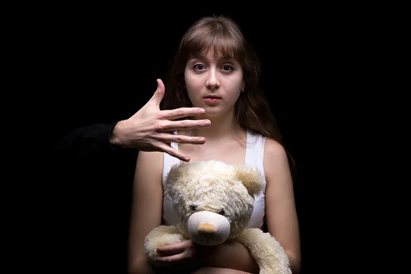 Scared teenage girl with teddy bear — Stock Photo, Image