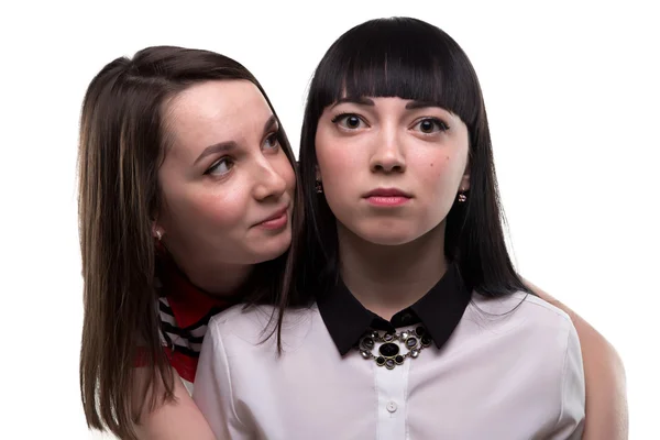 Two young brunette women - serious and smiling — Stock Photo, Image