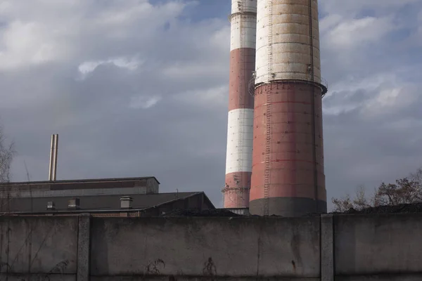 Close-up of chimneys and buildings by coal mine in Katowice. Industrial landscape. Global warming, CO2 emission, coal energy issues.