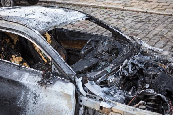 Burned car close-up.  Car after the fire, crime of vandalism, riots. Arson car. Accident on the road due to speeding. Explosion.