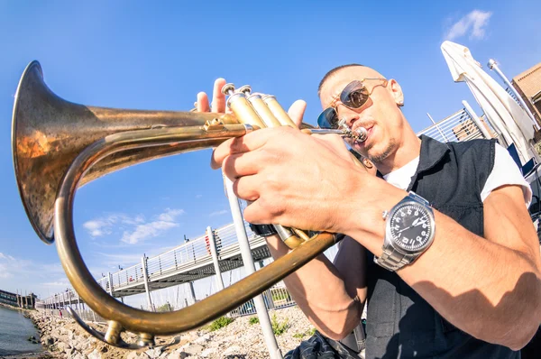Young man performing trumpet solo jazz at beach party - Music and street art concept at open air club location with groove mood atmosphere - Warm afternoon color tones with focus on musician face — Stock Photo, Image