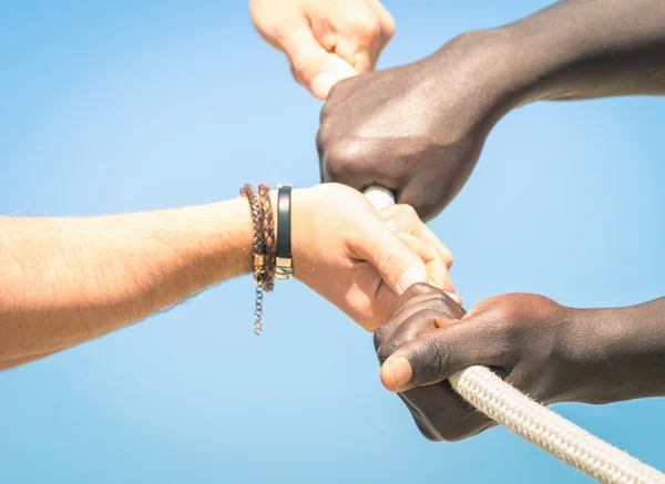 Tug of war - Concept of interracial multi ethnic union together against racism - Multiracial hands teamwork — Stock Photo, Image