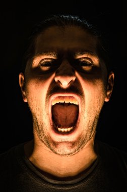 korku sahnesi korkunç insan yüzü siyah zemin - halloween kavramı ile genç adamla sert bir ışıkla çığlık ile açık ağız ve diş