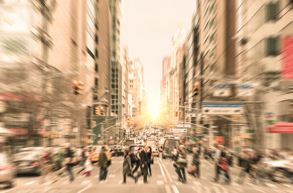 People on the street on Madison Avenue in Manhattan downtown before sunset in New York city - Commuters walking on zebra crossing during rush hour in american business district