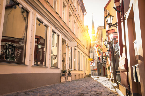 Vintage retro travel image of a narrow medieval street in old town Riga at sunset - Latvia - European capital of culture 2014