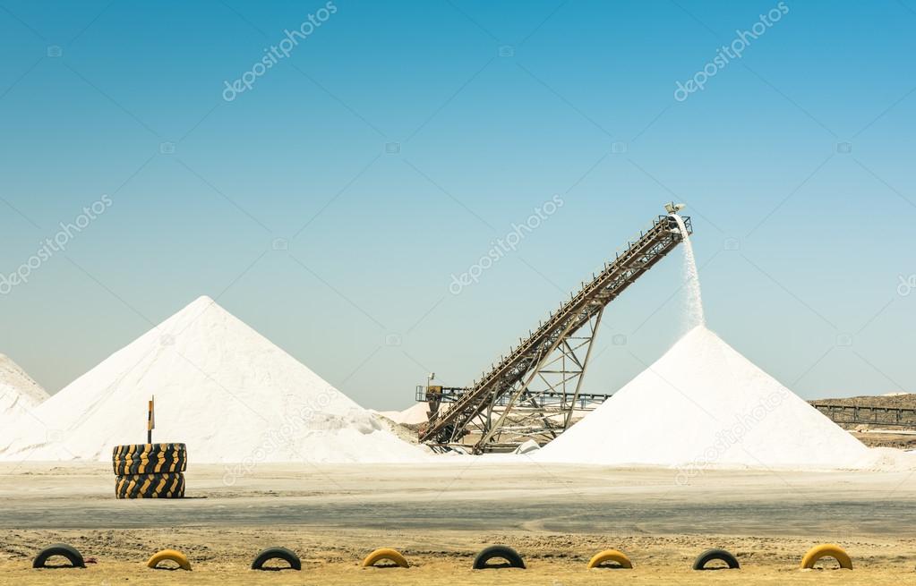 Industrial salt refinery with operating conveyor belt Emerging