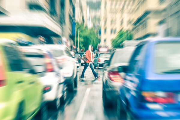 Person crossing the road during rush hour in Cape Town - Concept of connection between people and traffic jam on a vintage filtered look - Radial zoom defocusing of commuter cars on urban city streets