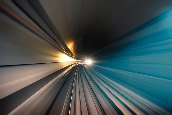 Subway tunnel with blurred light tracks in the gallery - Concept of modern metro underground transport and connection - Radial zoom motion blur due to the speed of the train — Stock Photo, Image