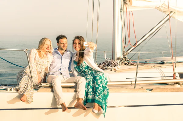 Young people taking selfie on exclusive luxury sailing boat - Co